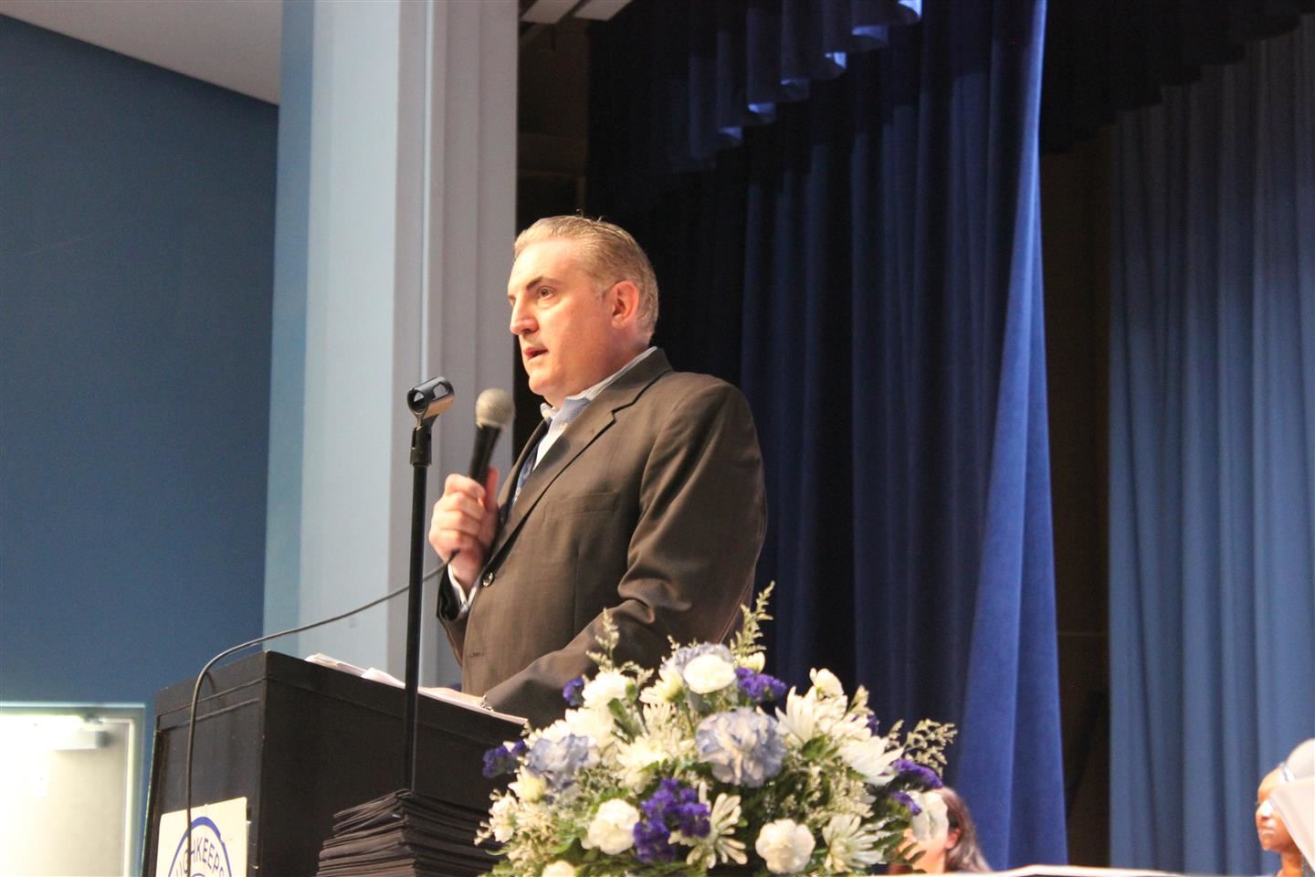 Robert Parkes speaks into a microphone